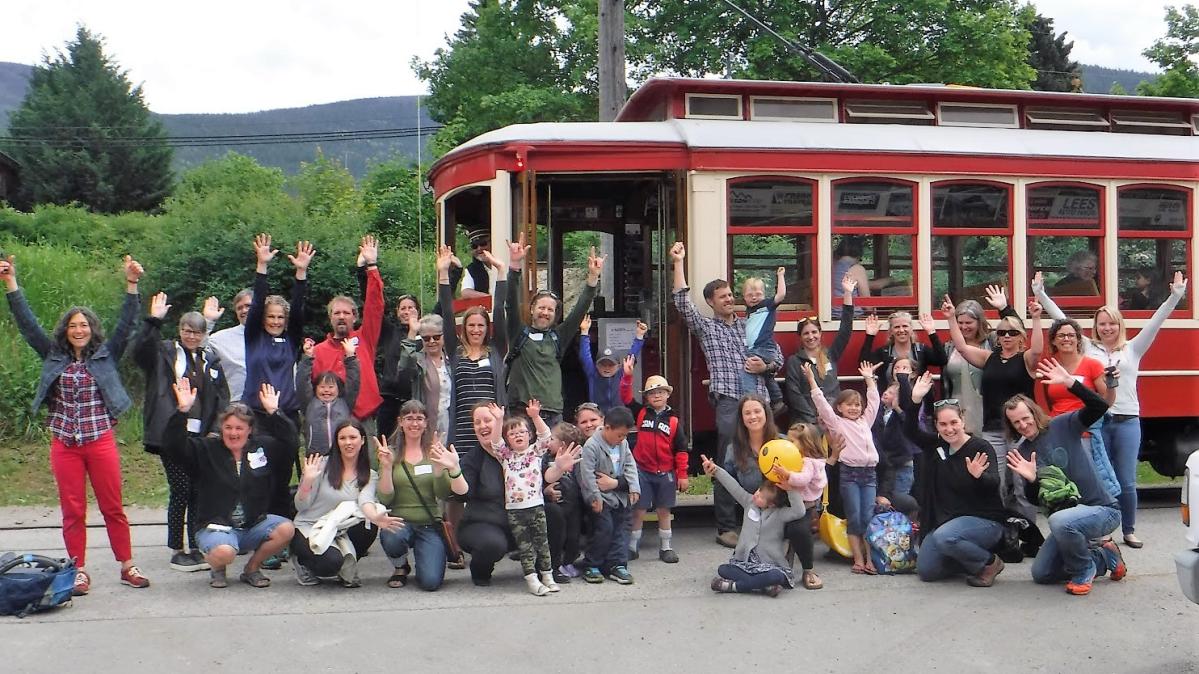 Inclusive Education staff standing in front of trolley